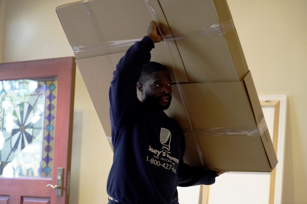 Professional movers wrap and secure glass table tops so they are not damaged in transit.